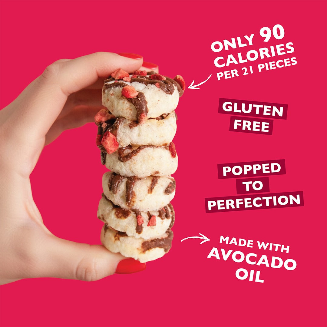 Hand holding a stack of strawberry-chocolate drizzled mini rice cakes